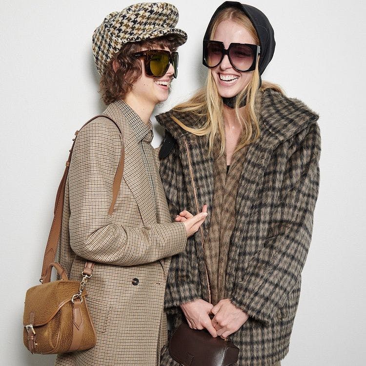 clothing apparel sunglasses accessories person overcoat coat sleeve handbag bag