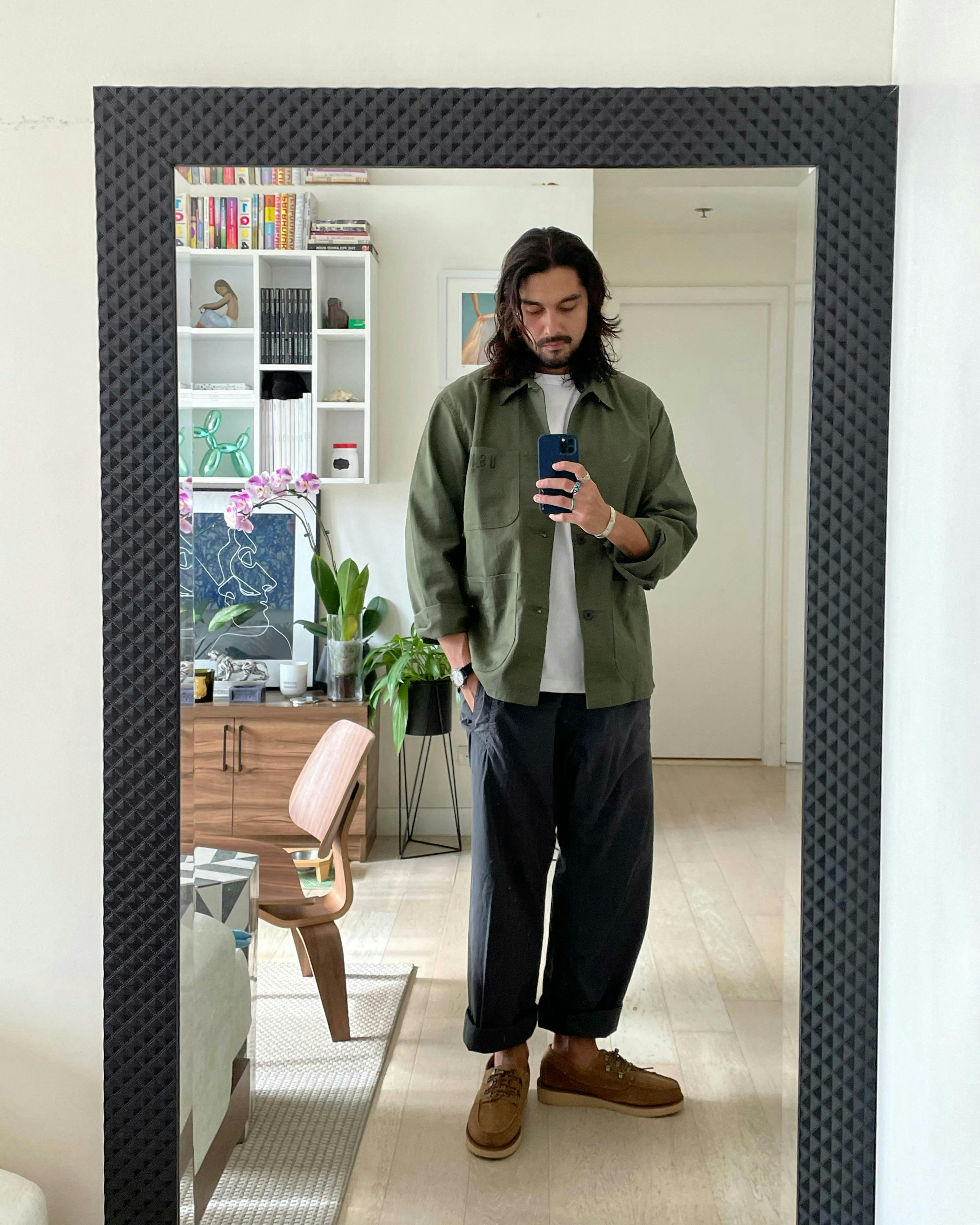 clothing apparel person human flooring footwear wood overcoat coat