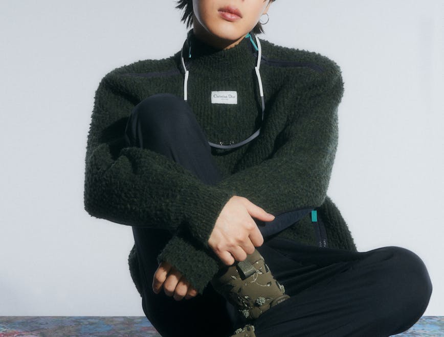 sitting person sweater knitwear clothing pants