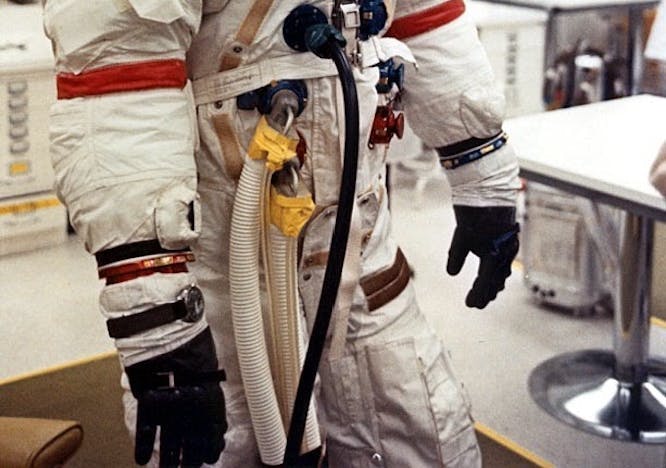 helmet adult male man person clothing glove astronaut