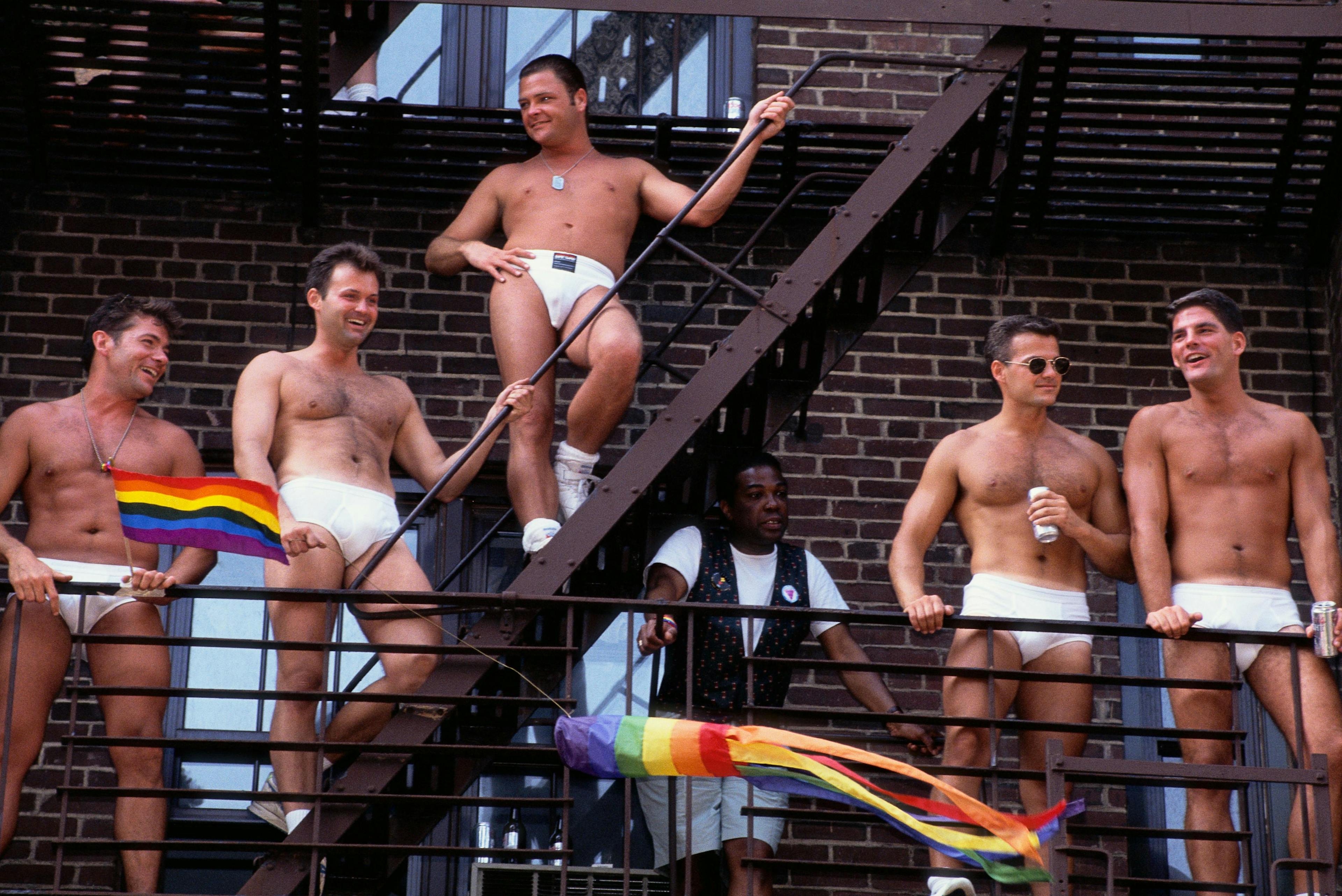 enjoyment:cb2 festivity:cb2 african-american ethnicity:cb3 ethnic diversity:cb2 group of people:cb3 gay male:cb3 caucasian ethnicity:cb3 political and social issues:cb2 urban scene:cb2 partially nude:cb2 gay rights:cb2 outdoors:cb2 celebrating:cb3 latin american and hispanic ethnicity:cb3 american:cb3 fire escape:cb3 city:cb2 pride parade:cb2 manhattan:cb2 back person shorts swimwear adult male man underwear undershirt brick